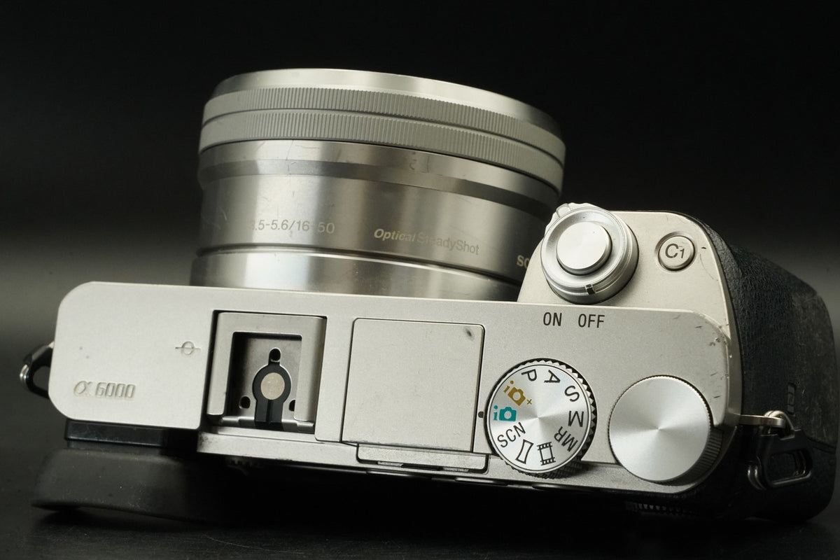 Sony a6000 Digital Mirrorless Camera Silver w/ 16-50 + 55-210mm 31032 cut #12012