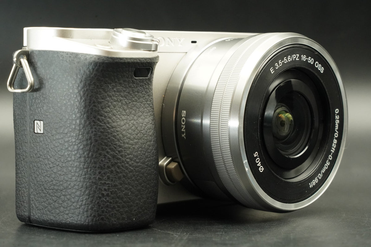 Sony a6000 Digital Mirrorless Camera Silver w/ 16-50 + 55-210mm -959 cut #12175